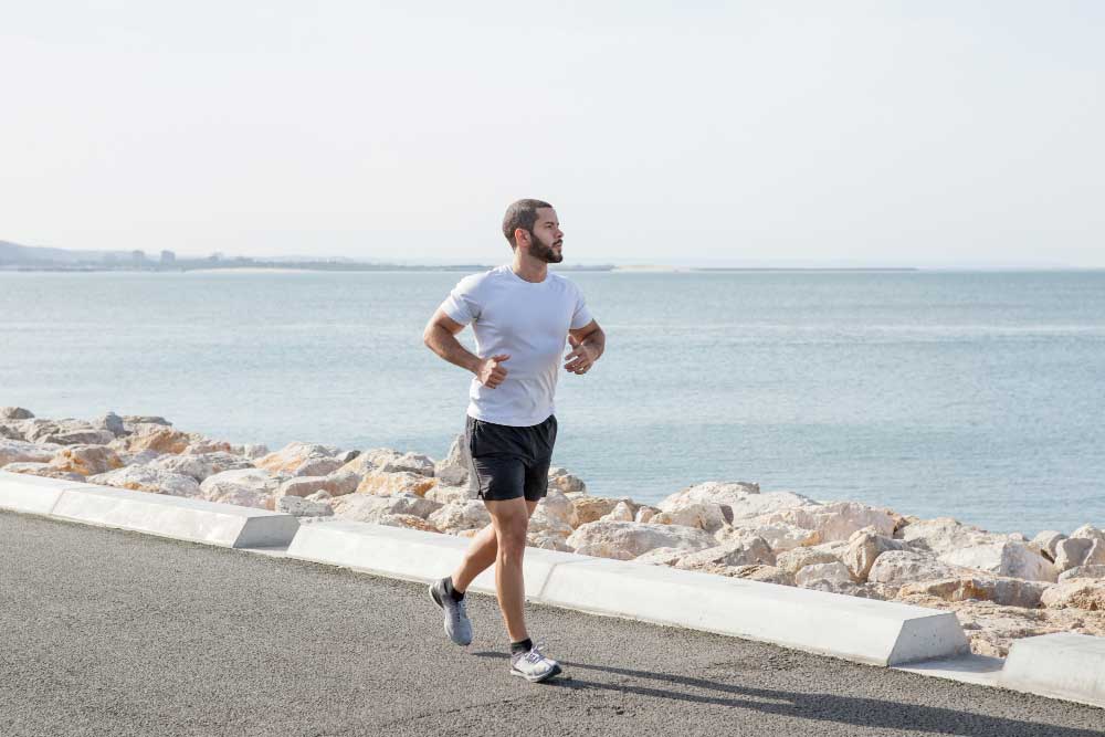 serious muscular man running seaside road 1 PRP Treatment PRP Treatment,PLATELET RICH PLASMA,noracare wellness